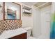 A bathroom featuring a shower, tiled mosaic backsplash, sink and vanity at 11431 W Lake Dr, Littleton, CO 80127
