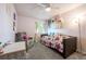 A bedroom with natural light, a ceiling fan, decor, gray chair and carpet at 11431 W Lake Dr, Littleton, CO 80127