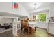 Bright dining room with a large window, hardwood floors, and a spacious table, perfect for Gathering gatherings at 11431 W Lake Dr, Littleton, CO 80127