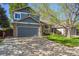 Charming two-story home with a well-manicured front yard and attached garage at 11431 W Lake Dr, Littleton, CO 80127