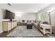 Spacious living room featuring a comfortable sectional sofa, a large TV, and modern decor, perfect for relaxation at 11431 W Lake Dr, Littleton, CO 80127