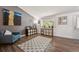 Bright living room featuring wood flooring, an accent wall, ample natural light, and cozy furniture at 11431 W Lake Dr, Littleton, CO 80127