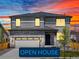 Two-story house with stone and gray siding, two-car garage, and landscaped yard at 6117 Camprock Way, Brighton, CO 80601