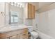 Bright bathroom with light wood cabinets, vanity and tub shower combo at 3006 W 107Th Pl # D, Westminster, CO 80031