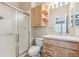 Bright bathroom featuring a glass-enclosed shower, vanity, and a mirrored medicine cabinet at 3006 W 107Th Pl # D, Westminster, CO 80031