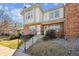 Brick townhome with a well-maintained front lawn, and a small stairway to the entrance at 3006 W 107Th Pl # D, Westminster, CO 80031