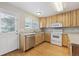 Kitchen area featuring stainless steel dishwasher, white appliances, and plenty of natural light at 3006 W 107Th Pl # D, Westminster, CO 80031