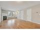 Open-concept living room with hardwood floors, fireplace, and staircase leading upstairs at 3006 W 107Th Pl # D, Westminster, CO 80031