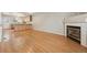 Spacious living room with hardwood floors, fireplace, and an open view to the kitchen at 3006 W 107Th Pl # D, Westminster, CO 80031