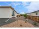 Well-maintained backyard featuring stone pathway, rock garden, and privacy fencing at 1592 Maggie Mae Ln, Castle Rock, CO 80104