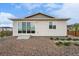Exterior view highlighting the backyard with its rock garden and stepping stone pathway at 1592 Maggie Mae Ln, Castle Rock, CO 80104