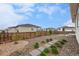 Inviting backyard with a wooden fence, rock garden, and stepping stones leading to the home at 1592 Maggie Mae Ln, Castle Rock, CO 80104