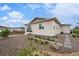 Stylish backyard featuring rock landscaping, stepping stones, and access to the house at 1592 Maggie Mae Ln, Castle Rock, CO 80104