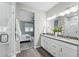 Elegant bathroom featuring double sink vanity, walk-in shower and wood-look flooring leading to the bedroom at 1592 Maggie Mae Ln, Castle Rock, CO 80104
