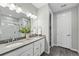 Modern bathroom with double sinks, walk-in shower, and stylish fixtures at 1592 Maggie Mae Ln, Castle Rock, CO 80104