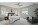 Cozy bedroom with a ceiling fan, soft carpeting, and comfortable seating area at 1592 Maggie Mae Ln, Castle Rock, CO 80104