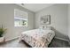 Cozy bedroom with a bed, window, modern art, and carpeted floor creating a comfortable retreat at 1592 Maggie Mae Ln, Castle Rock, CO 80104