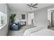 Serene bedroom features a cozy armchair, side table, and leafy green plant at 1592 Maggie Mae Ln, Castle Rock, CO 80104