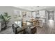 Bright dining area with a glass-top table and modern decor, adjacent to the kitchen at 1592 Maggie Mae Ln, Castle Rock, CO 80104