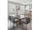 Stylish dining area with a glass top table and modern chairs near a well-equipped kitchen at 1592 Maggie Mae Ln, Castle Rock, CO 80104