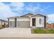 Charming single-Gathering home boasting a three-car garage, and modern architectural design with stone accents at 1592 Maggie Mae Ln, Castle Rock, CO 80104