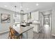 Modern kitchen features a large island, stainless steel appliances, and stylish pendant lighting at 1592 Maggie Mae Ln, Castle Rock, CO 80104