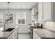 Well-lit kitchen featuring stainless steel appliances, white cabinetry, and a large island with bar seating at 1592 Maggie Mae Ln, Castle Rock, CO 80104