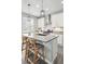 Bright kitchen featuring white cabinetry, stainless steel appliances, and an island with bar seating at 1592 Maggie Mae Ln, Castle Rock, CO 80104