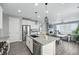 Bright kitchen with a gray island, stainless steel appliances, and a view of the living room at 1592 Maggie Mae Ln, Castle Rock, CO 80104
