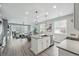 Open-concept kitchen with a center island, stainless steel dishwasher, and modern finishes at 1592 Maggie Mae Ln, Castle Rock, CO 80104
