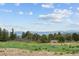 Beautiful acreage with meadow and mountain views in the background on a sunny day at 1592 Maggie Mae Ln, Castle Rock, CO 80104