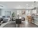 Bright living area flowing into a modern kitchen with a glass dining table set at 1592 Maggie Mae Ln, Castle Rock, CO 80104