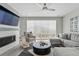 Beautiful living room with modern gray furniture, a fireplace, and plenty of natural light at 1592 Maggie Mae Ln, Castle Rock, CO 80104