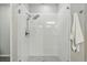 Beautiful walk-in shower with white subway tile, glass doors, and a modern rain shower head at 1592 Maggie Mae Ln, Castle Rock, CO 80104