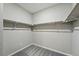 Functional walk-in closet with ample shelving and a carpeted floor for easy organization at 1592 Maggie Mae Ln, Castle Rock, CO 80104