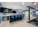 Entertainment bar featuring blue bar stools, flat screen television and modern pendant lighting at 2821 E Cedar Ave # 17, Denver, CO 80209
