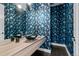 Contemporary powder room features modern vessel sink, wood vanity, and patterned wall paper at 2821 E Cedar Ave # 17, Denver, CO 80209