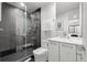Modern bathroom featuring dark gray tiled shower with glass door and sleek vanity at 2821 E Cedar Ave # 17, Denver, CO 80209