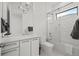 Bright bathroom with modern chandelier, decorative tile accent wall, and glass shower door at 2821 E Cedar Ave # 17, Denver, CO 80209
