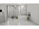Luxurious bathroom with a freestanding tub, glass-enclosed shower, and marble tile at 2821 E Cedar Ave # 17, Denver, CO 80209