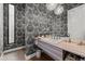 Chic half bath with patterned wallpaper, stylish lighting, and a modern vanity at 2821 E Cedar Ave # 17, Denver, CO 80209