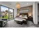 Spacious bedroom with decorative wallpaper, large window, and stylish furniture at 2821 E Cedar Ave # 17, Denver, CO 80209