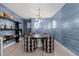 Modern dining room with blue wallpaper, contemporary lighting, and seating for four at 2821 E Cedar Ave # 17, Denver, CO 80209