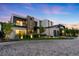 Elegant modern home with illuminated landscaping and a dramatic sunset backdrop, showcasing architectural design at 2821 E Cedar Ave # 17, Denver, CO 80209