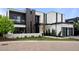 Modern home with a black and white exterior, accented with wood paneling and manicured landscaping at 2821 E Cedar Ave # 17, Denver, CO 80209