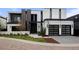 Striking modern home featuring a two-car garage, contrasting black and white facade, and minimalist landscaping at 2821 E Cedar Ave # 17, Denver, CO 80209