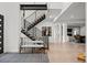Bright, open foyer with a modern staircase and light wood floors, flowing into a spacious living area at 2821 E Cedar Ave # 17, Denver, CO 80209