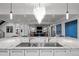 Open-concept kitchen overlooking the living room with a marble island and stylish pendant lighting at 2821 E Cedar Ave # 17, Denver, CO 80209