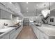 Bright kitchen featuring white cabinetry, stainless steel appliances, and a large center island at 2821 E Cedar Ave # 17, Denver, CO 80209