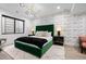 Spacious main bedroom with a stylish green headboard and unique lighting fixture at 2821 E Cedar Ave # 17, Denver, CO 80209